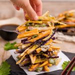 Vegetable tempura stacked and served on a black board ready to eat