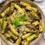 Mushroom pesto pasta served in a brown bowl.