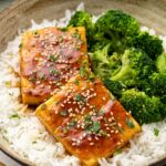 Close up of teriyaki tofu in brown bowl.