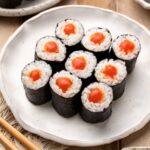Vegan spicy tuna rolls served on a white plate.