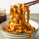 Garlic chili oil noodles in a bowl with chopsticks.