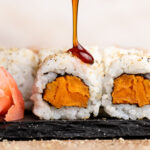 Sweet potato roll with teriyaki sauce drizzled on top.