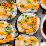 Vegetable dynamite roll with spicy mayo drizzled on top.